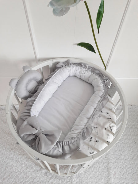 A collection of cozy baby nests nestled together, each adorned with playful animal designs and soft, plush fabrics. These inviting nests provide a safe and comfortable haven for infants, offering a sense of security and promoting restful sleep.