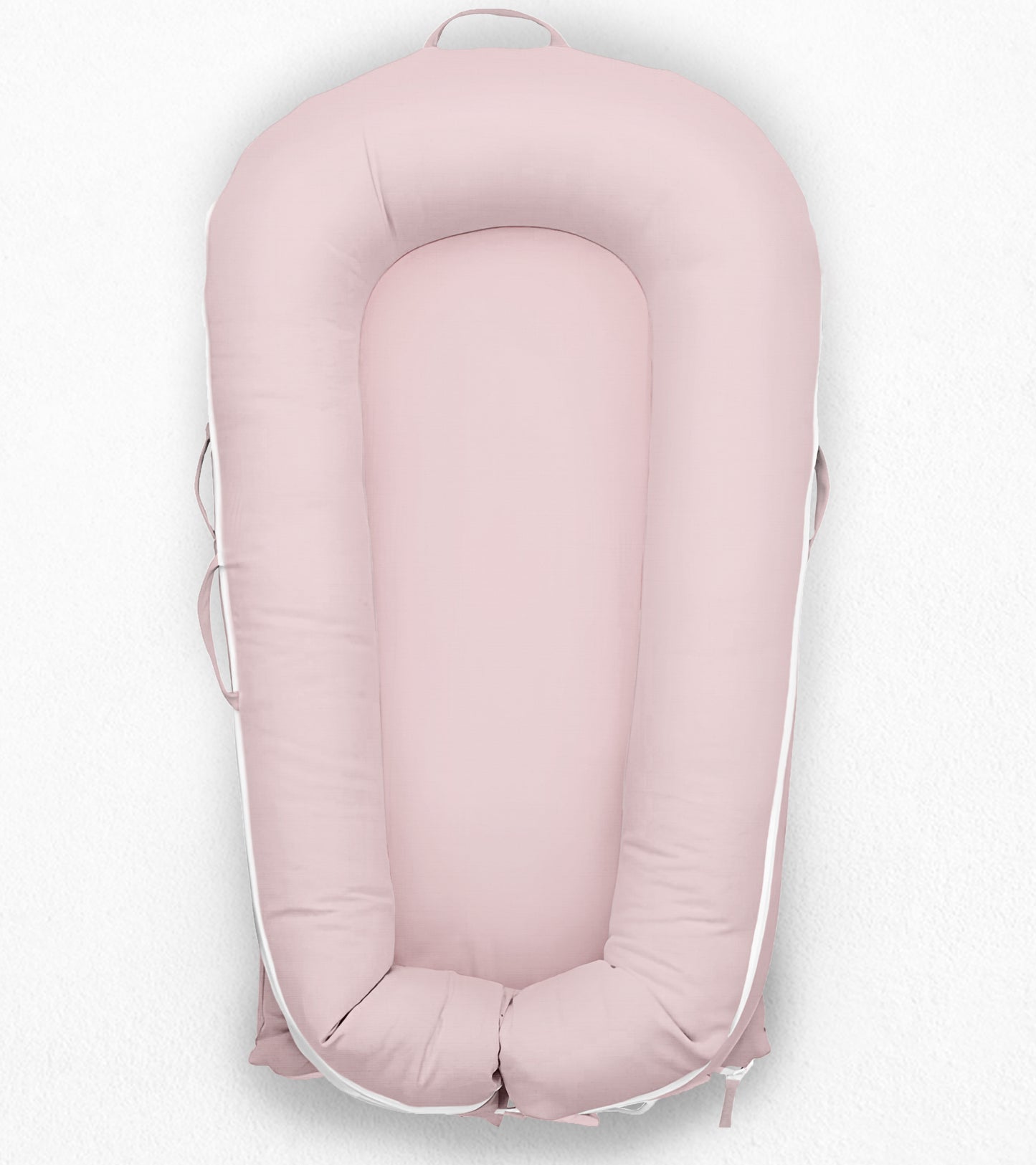 light pink Dockatot sleepyhead, white background, front side