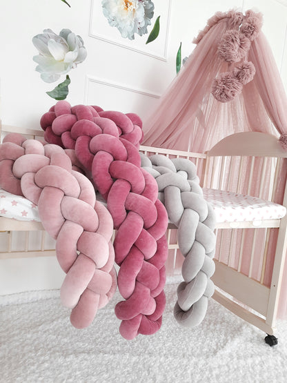 Light pink, fresia and gray braided bumpers on the crib with canopy