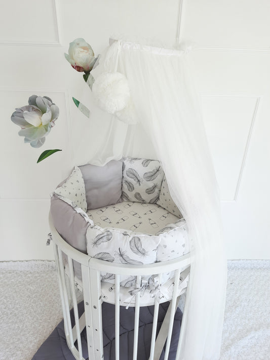 Crib set in white color. Pillow bumper, optional canopy, leaf mat and baby nest.