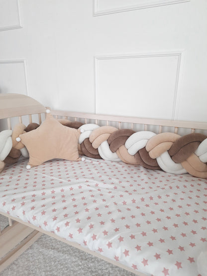 White-vanilla-brown double braided crib bumper  with vanilla star pillow on the crib. Best braided crib bumper for nursery