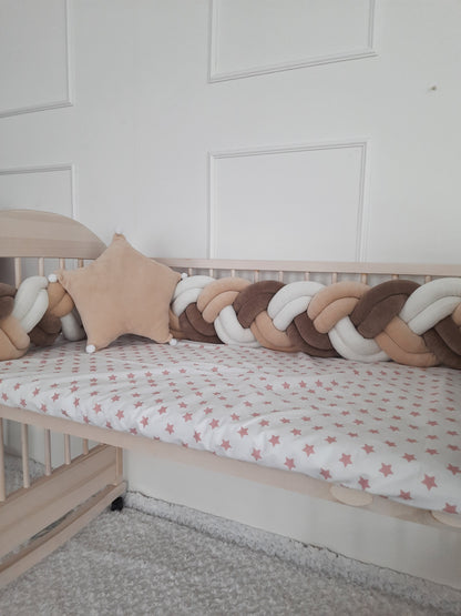 White-vanilla-brown double braided crib bumper  with vanilla star pillow on the crib. Best braided crib bumper for nursery