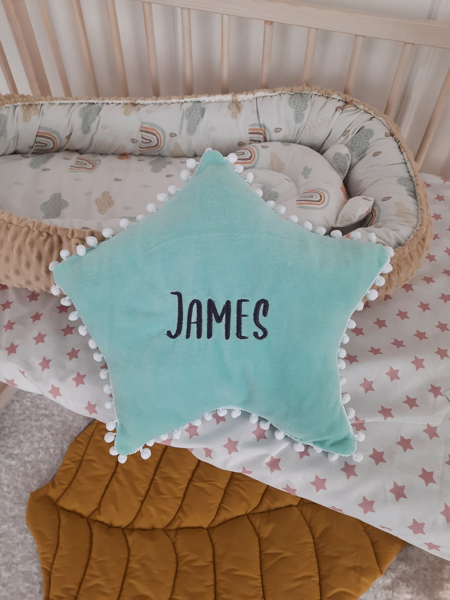 Blue star pillow and embroidered baby name James. Star pillow is a gift with the purchase of a braided crib bumper