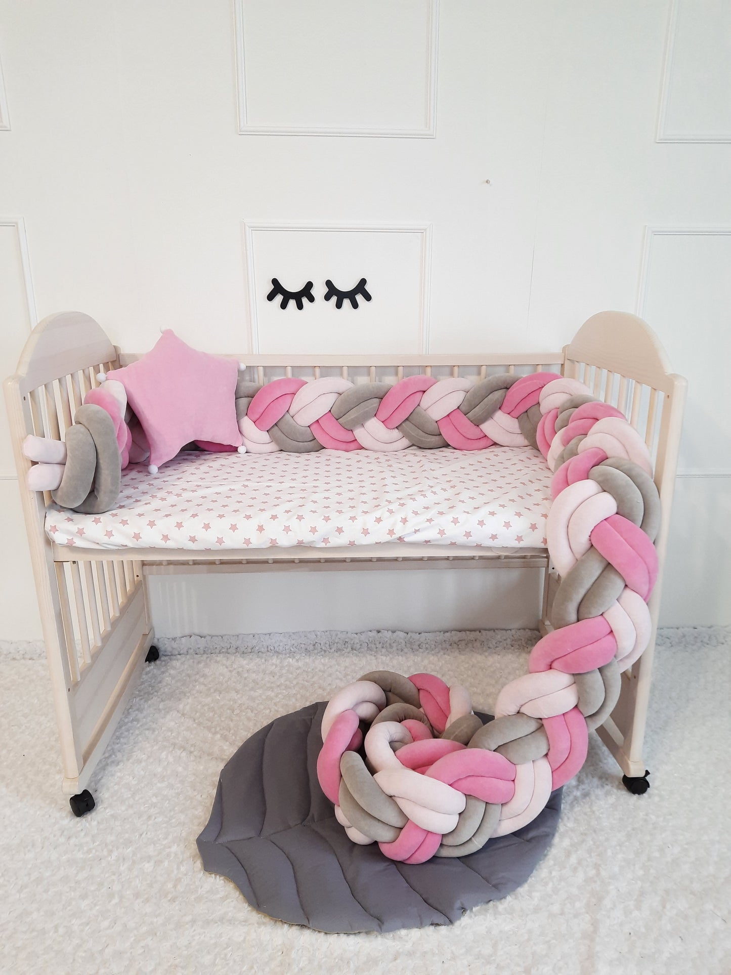 Long double braided cot bumper in 3 diffrent colors on the crib. Star pillow is a gift with the purchase of a braided crib bumper
