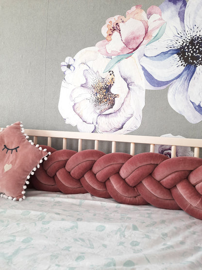 Fresia double braided crib bumper and star pillow on the crib. Close-up view, front side