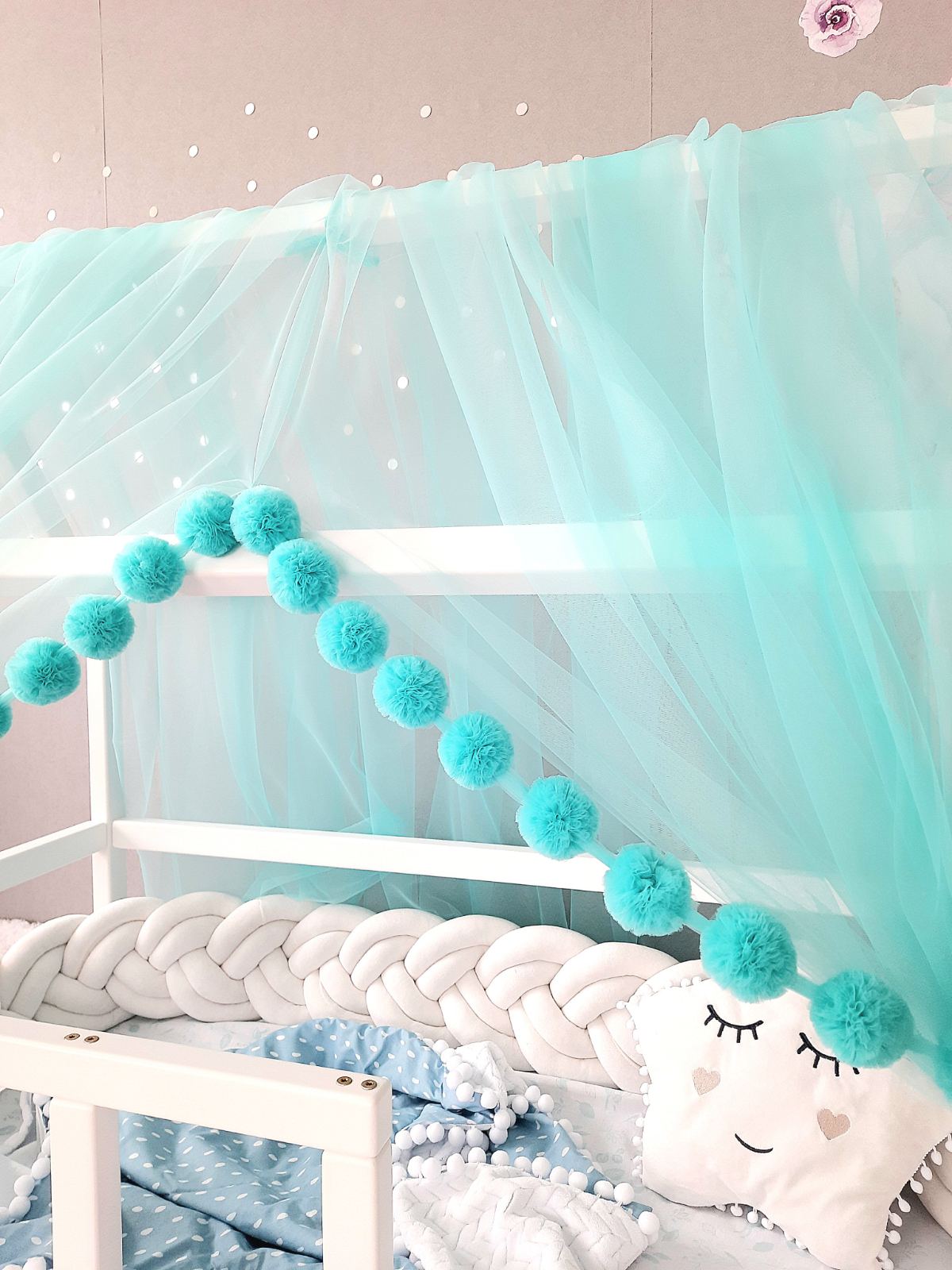 Aqua montessori canopy with pom poms for nurcery. Close up view