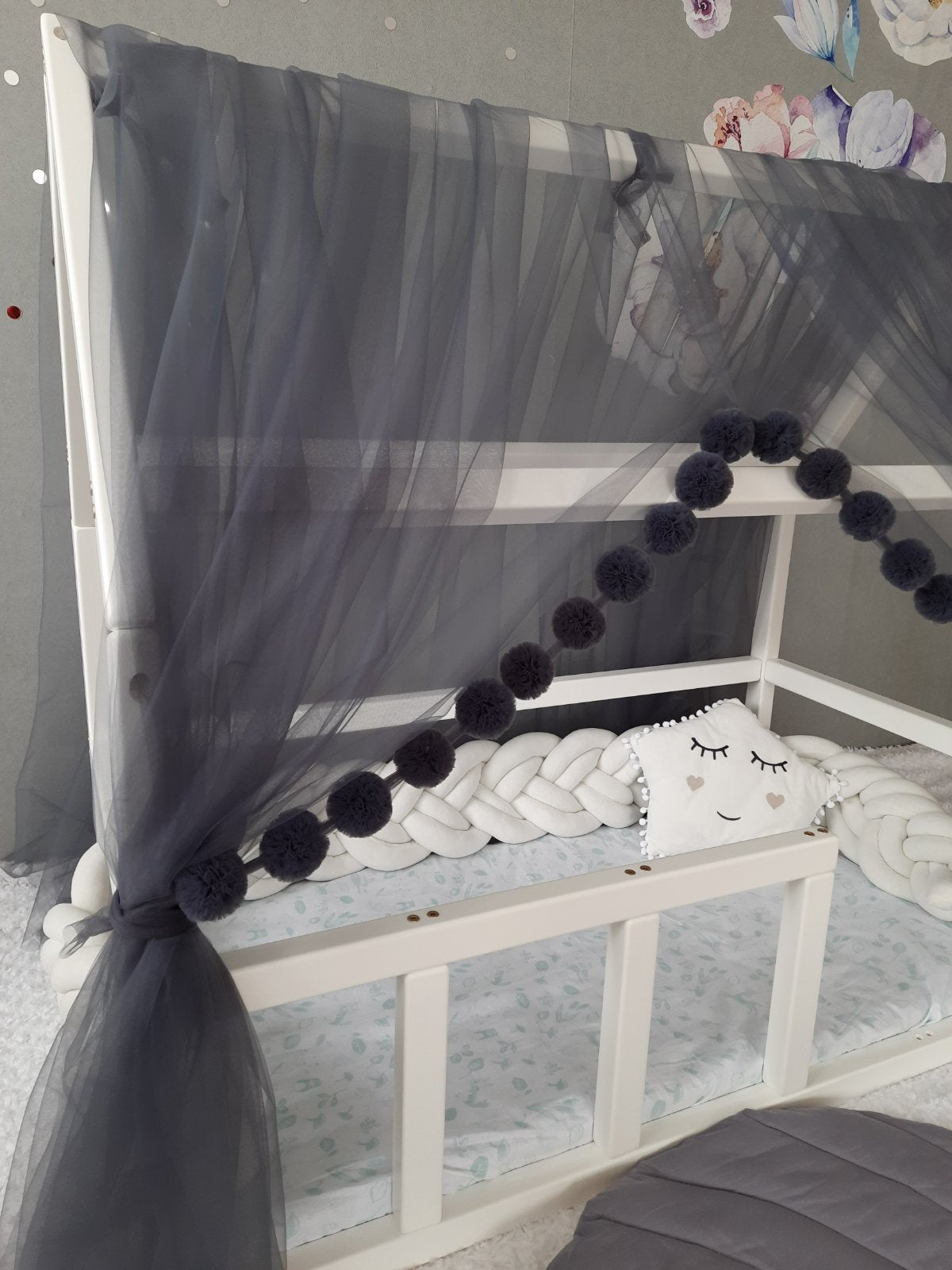 Darkgray montessori tulle canopy with pom poms. Close up view