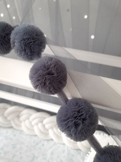 Dark gray montessori canopy pompoms. Close up view