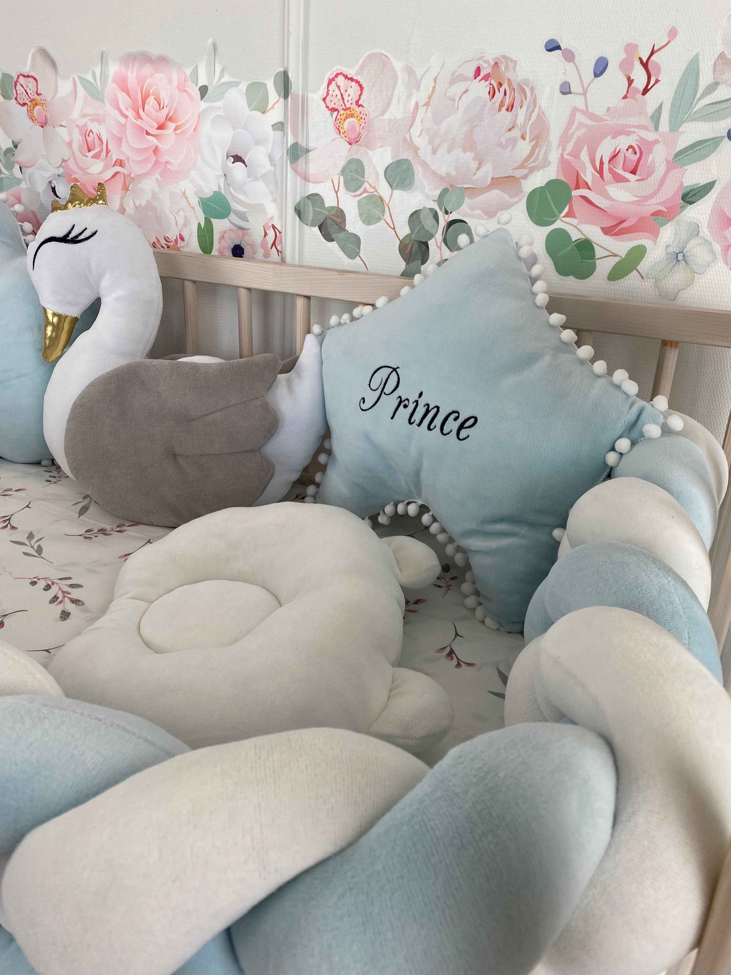 White orthopedic infant pillow, star pillow with custom embroider and white swan pillow with gray wings. Close up view