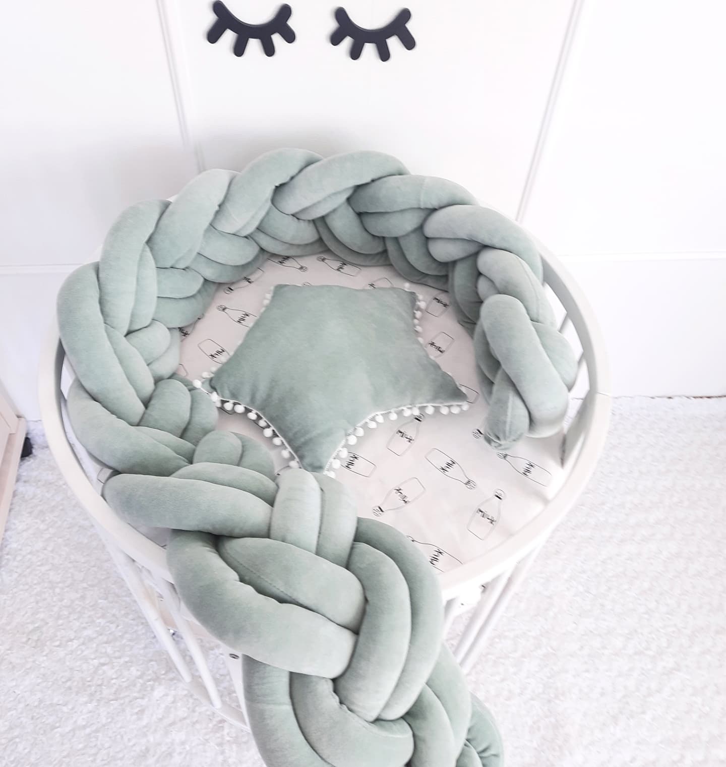 Light olive double braided cot bumper and star pillow. Top view