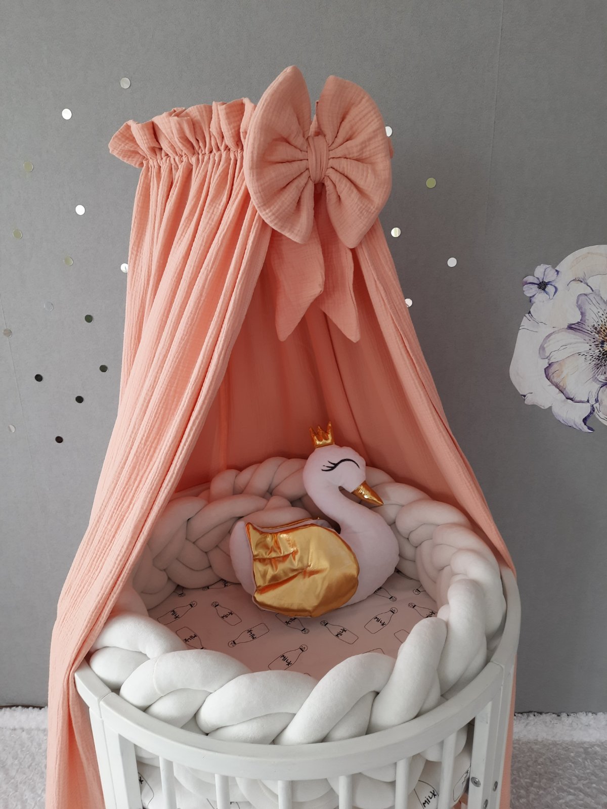 Muslin canopy in peach color with bow. Best canopy for baby`s bed. Swan pillow and bumper on the crib