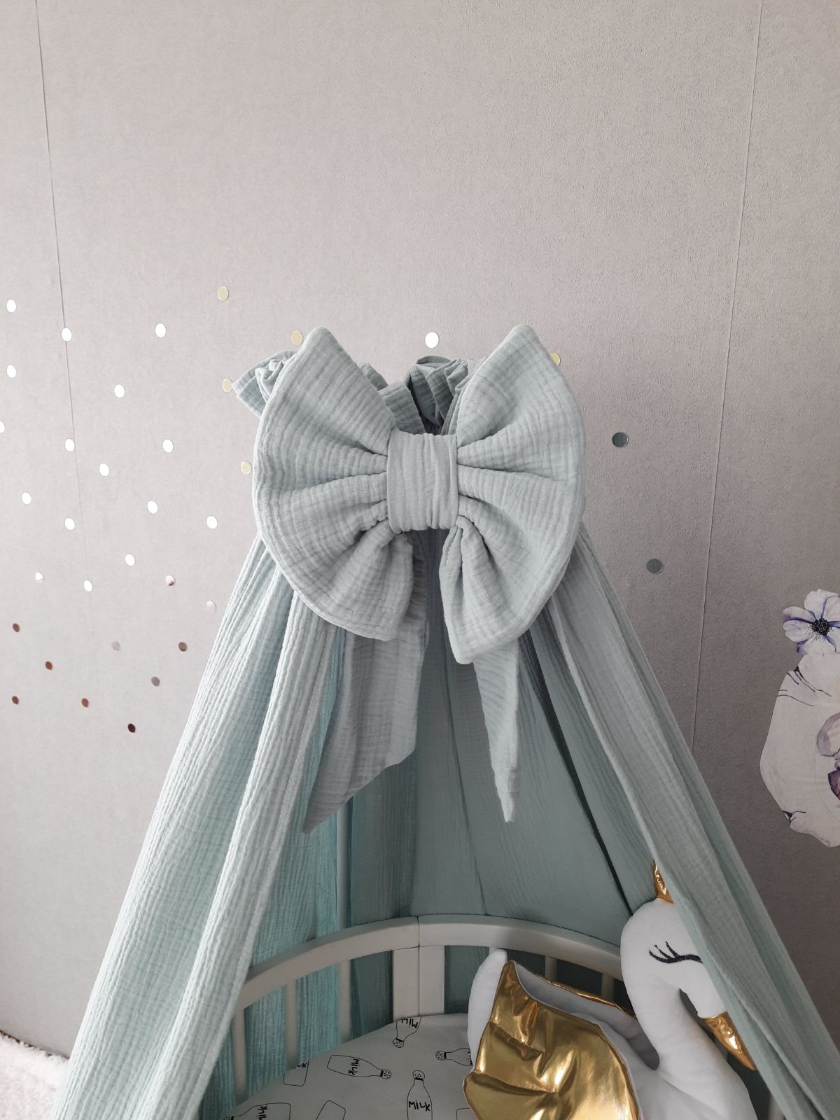 Muslin sage green canopy bow. Close up