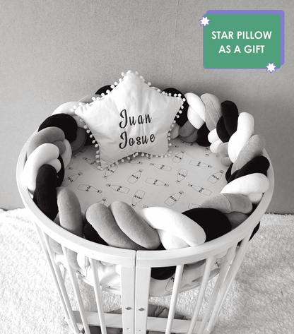 Double braided crib bumper and white star pillow with embroider of baby name on the oval crib. Star pillow as a gift