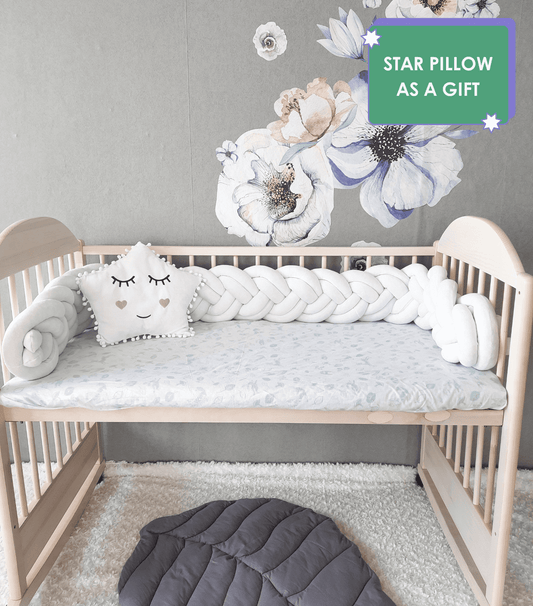 White double braided crib bumpers with white gray star pillow on the crib. Star pillow as a gift. Front side