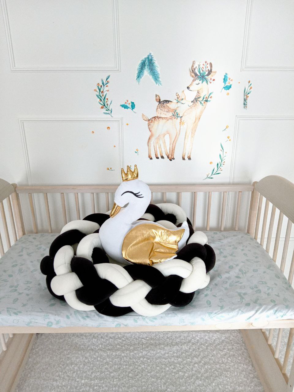 White-black Double Braided Crib Bumper with swan pillow on the crib. Front side