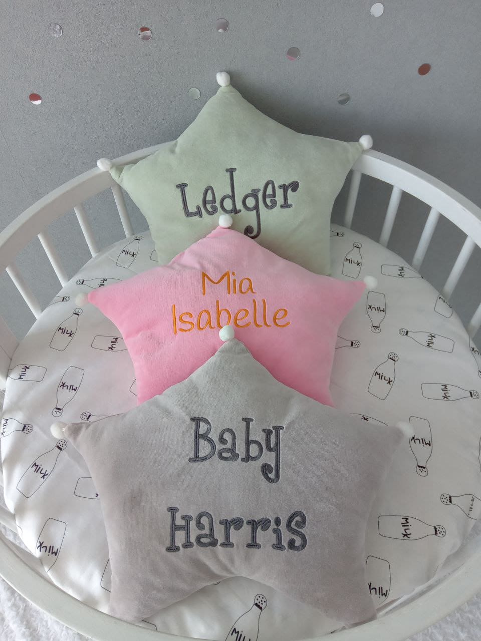 Light olive, pink and gray Allbright Kids star pillows. Top view