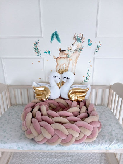 2 white swan pillows on top of the Allbright Kids double braided crib bumper