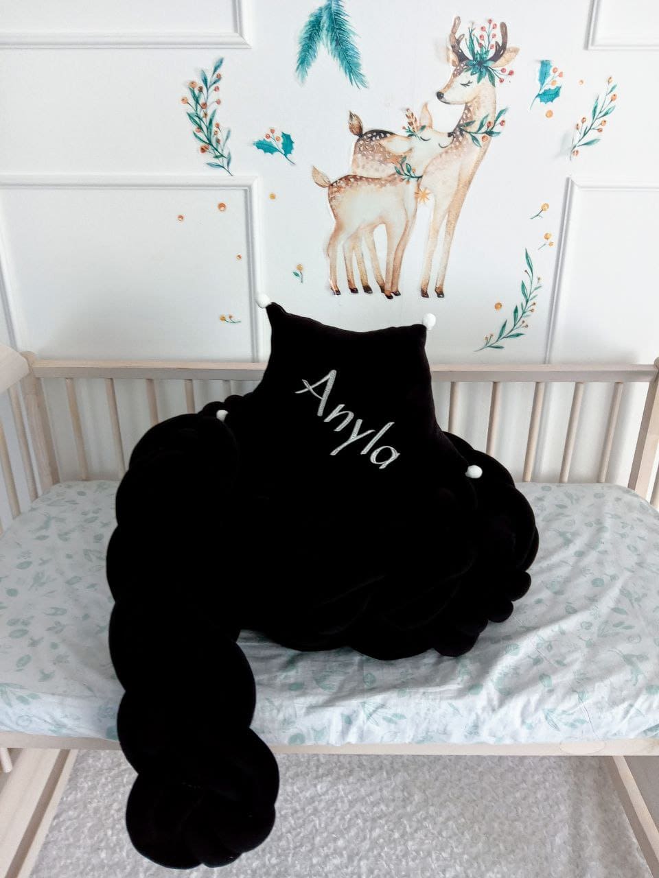 Allbright Kids black braided bumper and black star pillow with custom embroider on the crib 