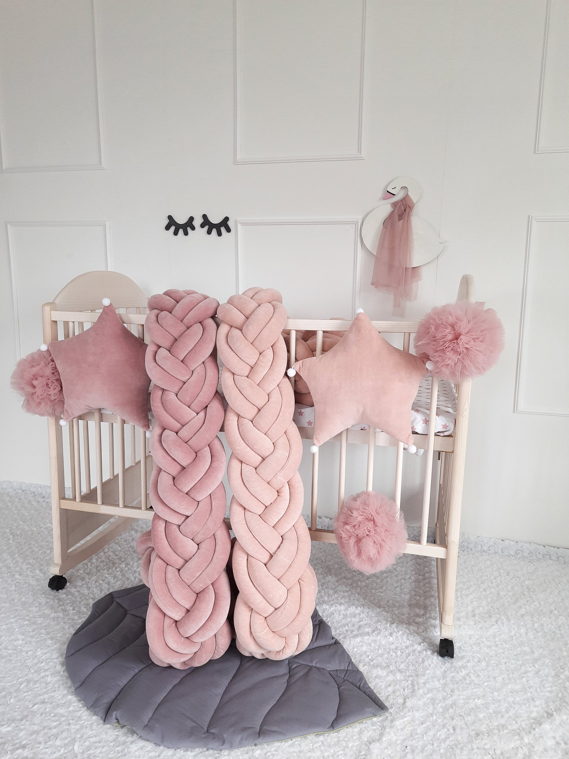 Rose and Blush Double braided crib bumper with rose and blush star pillows and pom poms on the crib. AllbrightKids goods for nursery