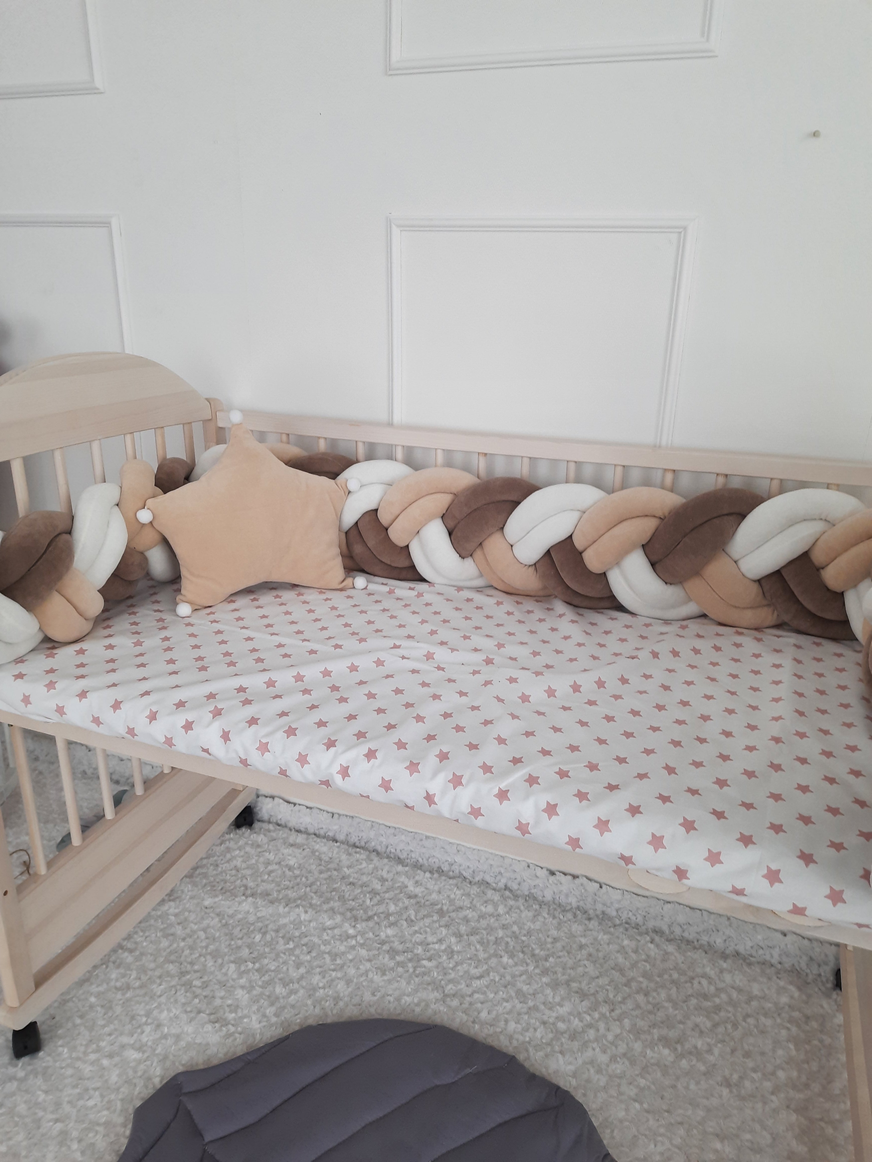 White-Brown-Coffee Double Braided Crib Bumper with star pillow on the crib.