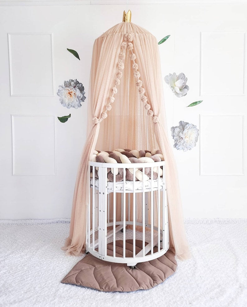 Beige nursery canopy for crib. In white baby room. Front side